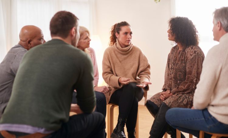Group of people in a supporting alcoholics meeting - Step by Step Recovery