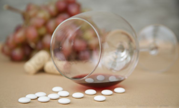 A toppled glass of wine and pregabalin pills - Step By Step Recovery